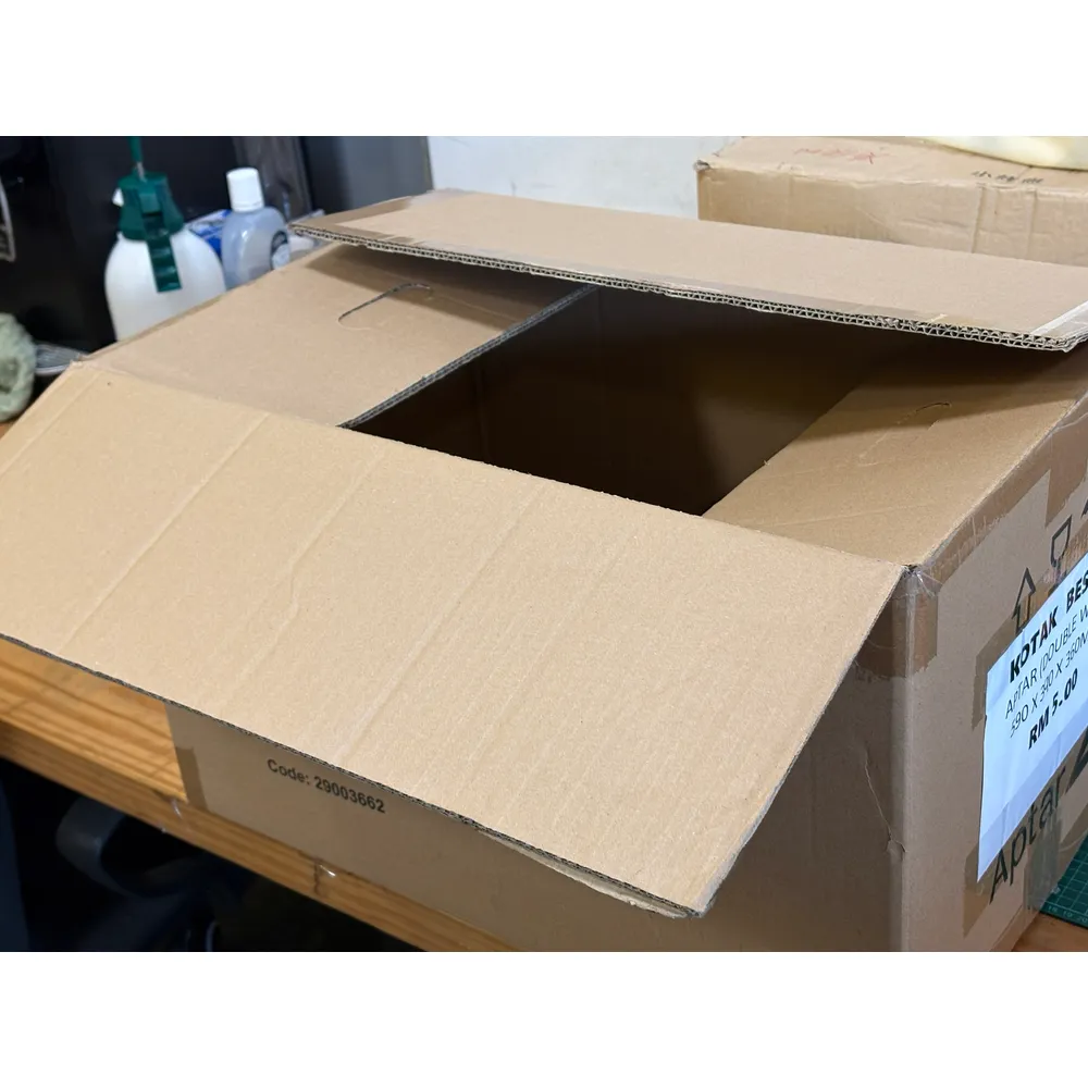 The APT box with its top flaps open on the packing bench, the Code 29003662 print of its first use on the side