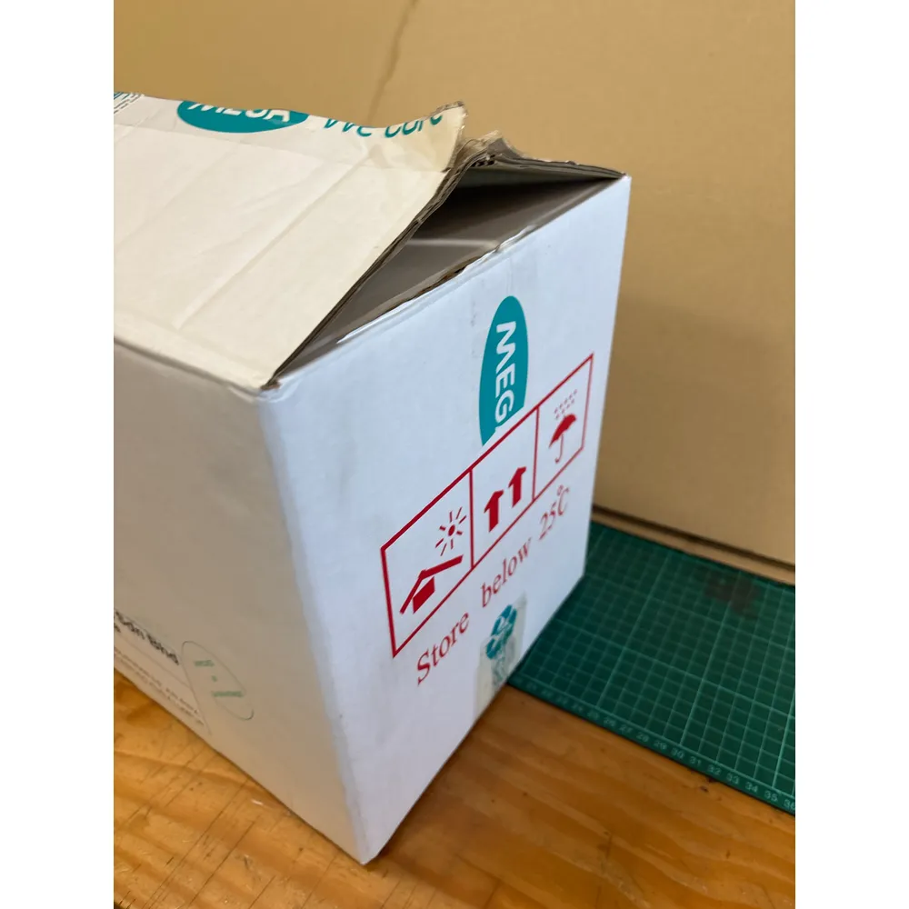 The end panel of the MG box with its Store below 25°C handling marks, one top flap folded back